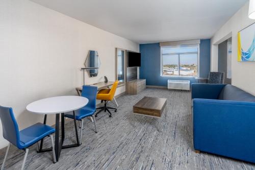 a living room with a couch and a table and chairs at Holiday Inn Express Hotel & Suites Cheyenne by IHG in Cheyenne