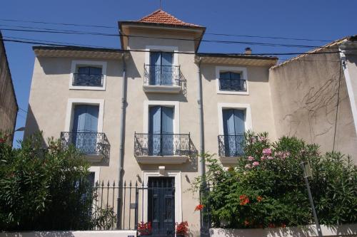 a large white house with a turret at Le Petit Molière in Servian
