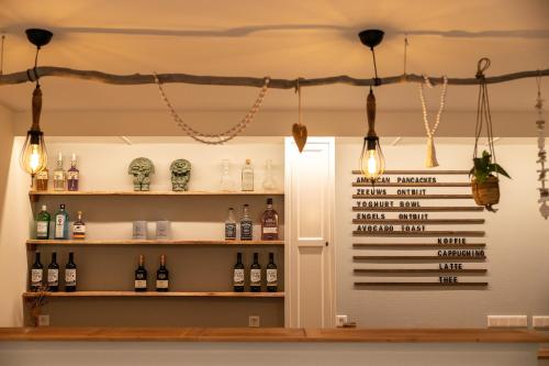 a wine shop with bottles of wine on shelves at B&B Iets Zeeuws in Kats