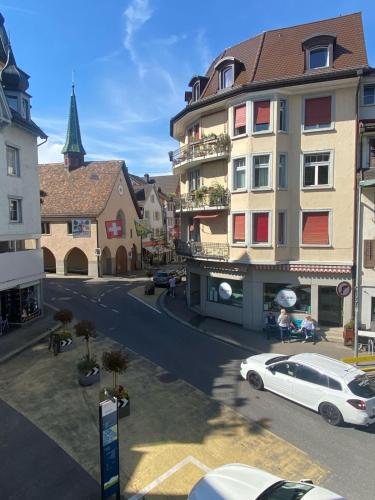 a white car parked in front of a building at Zentrales Schloss Apartment in Arbon