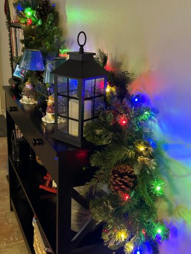 a table with a christmas tree and a lantern at Rare four Bedroom MeadviewVacation Home - Grand Canyon West-Skywalk in Meadview