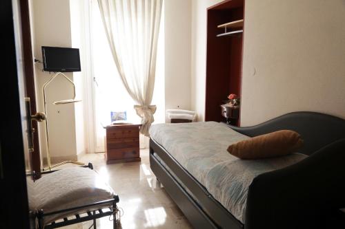 a bedroom with a bed and a window at Aurora in Castione della Presolana