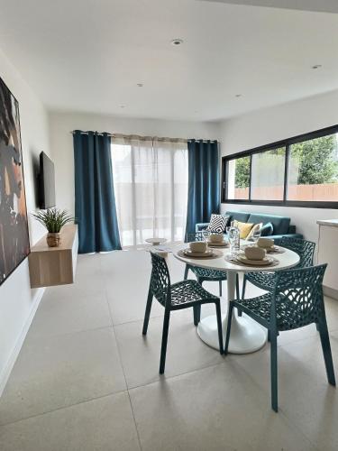 Una sala de estar con una mesa de comedor y sillas. en Le Baule D'air, en La Baule