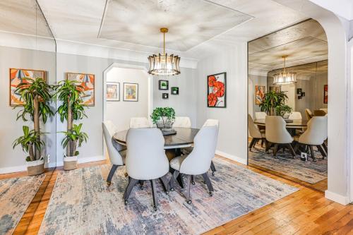 a dining room with a table and chairs at 2 Mi to Downtown Flushing Spacious Retreat! in Flint