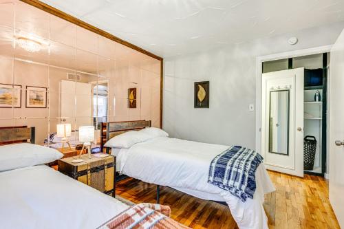 a bedroom with two beds and a table at 2 Mi to Downtown Flushing Spacious Retreat! in Flint
