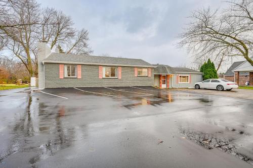 a car parked in a parking lot in front of a house at 2 Mi to Downtown Flushing Spacious Retreat! in Flint