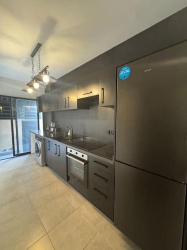a kitchen with a refrigerator and a stove top oven at Sublime Appartement Marrakech in Marrakech