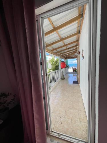 an open door to a balcony with a view of the ocean at Cabaña sunrise view in Providencia