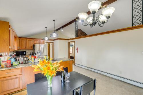 a kitchen with a table with a vase of flowers on it at Peek-a-Boo Lake Views and Yard Windham Home in Salem