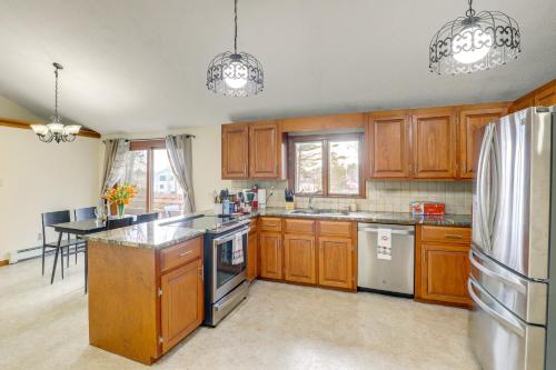 a kitchen with wooden cabinets and stainless steel appliances at Peek-a-Boo Lake Views and Yard Windham Home in Salem