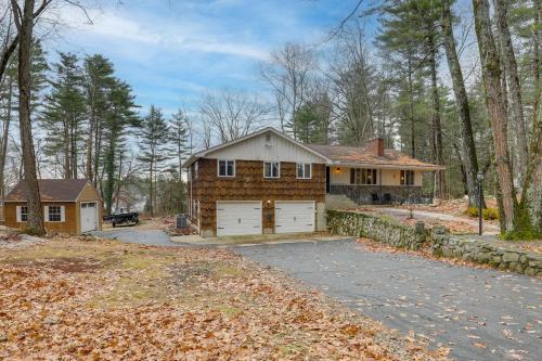 a house with a garage in the woods at Peek-a-Boo Lake Views and Yard Windham Home in Salem