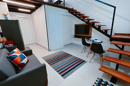 a living room with a staircase and a tv at Mini Loft Siena in Sinop