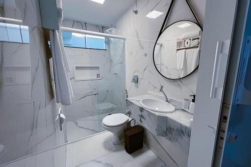 a bathroom with a toilet and a sink and a mirror at Mini Loft Siena in Sinop