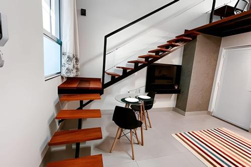 a room with stairs and a table and chairs at Mini Loft Siena in Sinop