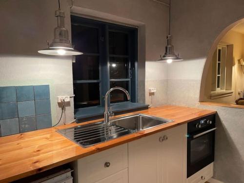 a kitchen with a sink and a counter top at Hyggeligt lille charmerende hus in Borre