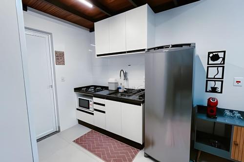 a kitchen with a stainless steel refrigerator and a sink at Mini Loft Siena in Sinop