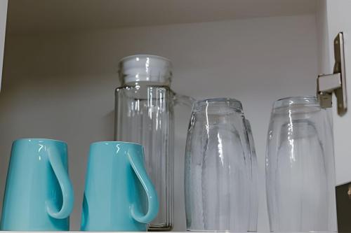 three glass mason jars sitting on top of a shelf at Mini Loft Siena in Sinop