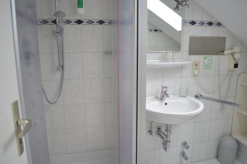 a bathroom with a sink and a shower at Alte Post - Hotel Am Rhein-Ufer Laufenburg in Laufenburg