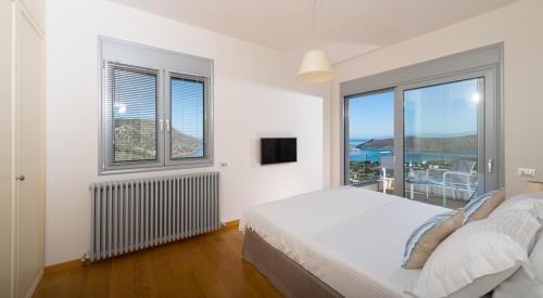 Ένα ή περισσότερα κρεβάτια σε δωμάτιο στο Elounda Luxury Villas