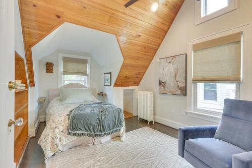 a bedroom with a bed and a blue chair at Walk to Roanoke River Greenway Mountain-View Home in Roanoke