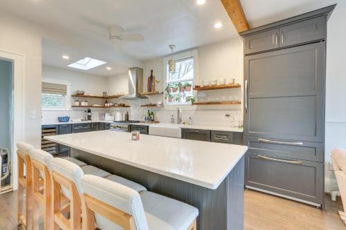 a kitchen with a large kitchen island with white counter tops at Walk to Roanoke River Greenway Mountain-View Home in Roanoke