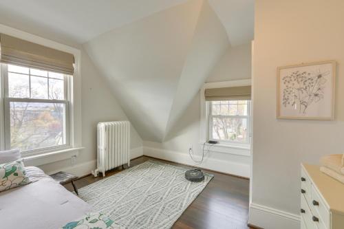an attic room with a bed and two windows at Walk to Roanoke River Greenway Mountain-View Home in Roanoke