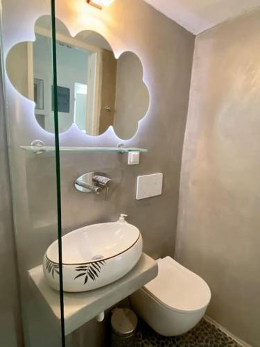 a bathroom with a sink and a toilet at Cyclops House in Serifos Chora