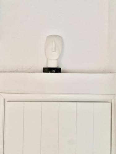 a white door with a candle on top of it at Cyclops House in Serifos Chora