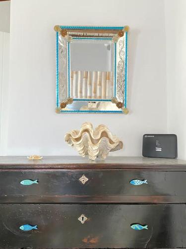 a mirror sitting on top of a dresser at Cyclops House in Serifos Chora