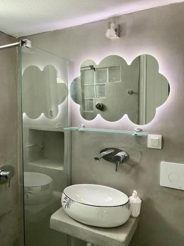 a bathroom with a sink and a mirror at Cyclops House in Serifos Chora