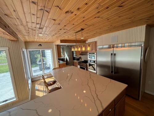 a kitchen with a stainless steel refrigerator and a counter at Island Estate in La Pointe