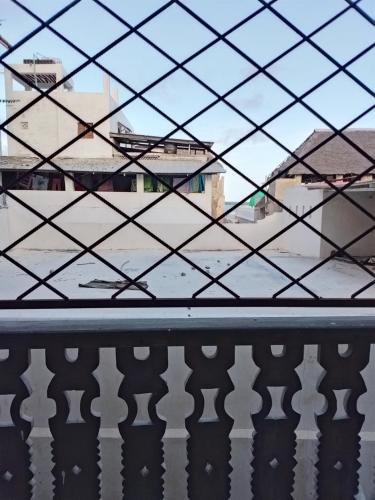 a view from a window of a balcony at Precious Bungalow House in Lamu