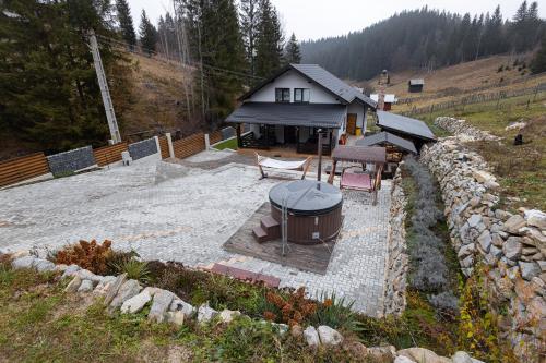 a backyard with a hot tub and a house at Cabana la Piatră in Pojorîta