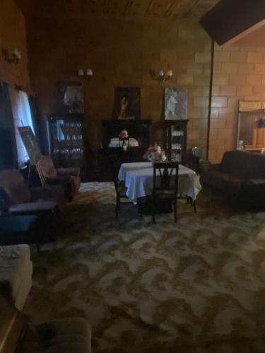 a living room with a table and couches at Gogol House in Kutaisi