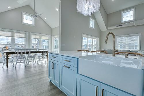 a kitchen with blue cabinets and a dining room with a table at South Bethany --- 102 Brandywine Dr in Bethany Beach