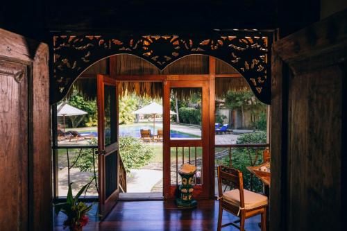 an entrance to a house with an open door at Turtle Inn by Francis Ford Coppola in Placencia Village