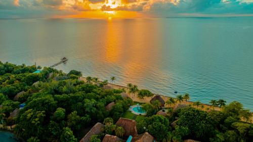 an aerial view of a resort on the water at sunset at Turtle Inn by Francis Ford Coppola in Placencia Village