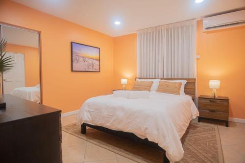 a bedroom with a large bed and a large mirror at Arashi Beachfront - The best sunsets in Aruba! in Madiki