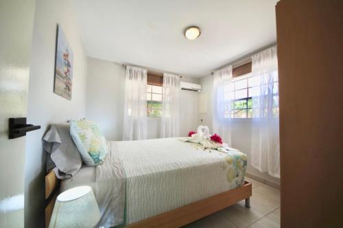 a bedroom with a bed with a stuffed animal on it at Beija Flor Entire home in Oranjestad, Aruba in Paradijs