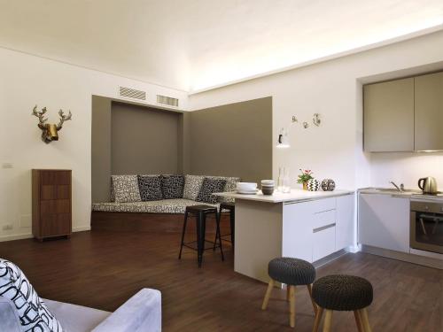 a kitchen and living room with a couch and a table at Le Tre Madame in Turin