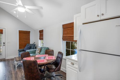 a kitchen with a refrigerator and a table with chairs at Town of Rehoboth Beach - 46 Delaware Ave, Unit C in Rehoboth Beach