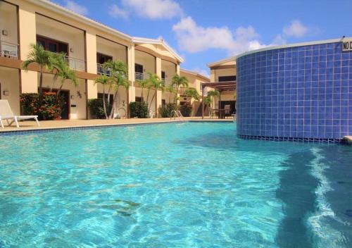 a large swimming pool in front of a building at Aruba Breeze Condo A5 in Palm-Eagle Beach