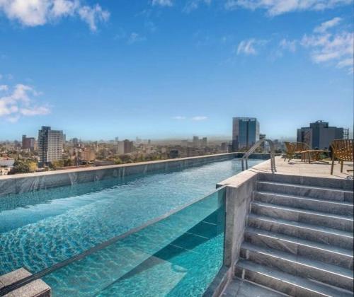 a swimming pool on the roof of a building at Ultimate Getaway in Luxe Studio in Mexico City