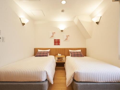 Postel nebo postele na pokoji v ubytování Hotel Toms