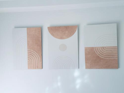 three pictures on a white wall with cork at BATUU Luxury Living in Bizerte