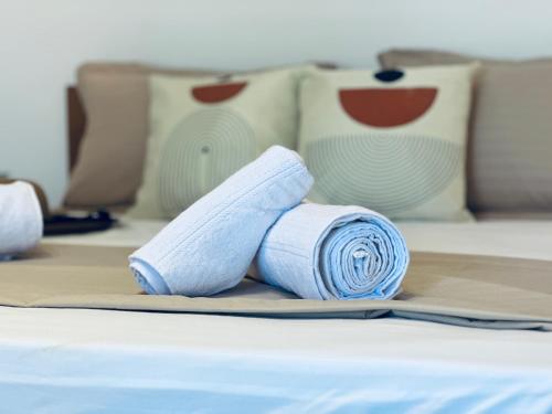a rolled up towel sitting on top of a bed at BATUU Luxury Living in Bizerte