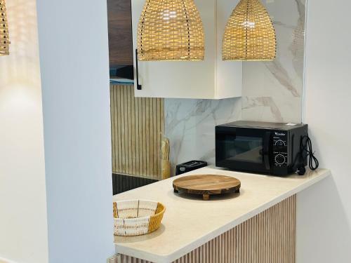 a microwave sitting on a counter in a kitchen at BATUU Luxury Living in Bizerte