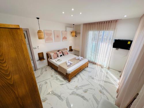 a bedroom with a bed with a marble floor at BATUU Luxury Living in Bizerte