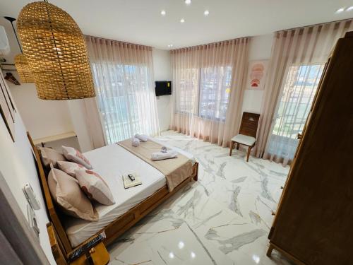 a bedroom with a bed with a marble floor at BATUU Luxury Living in Bizerte