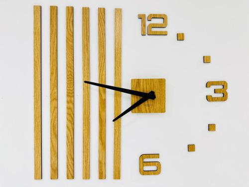 a large clock with brown numbers on a white background at BATUU Luxury Living in Bizerte